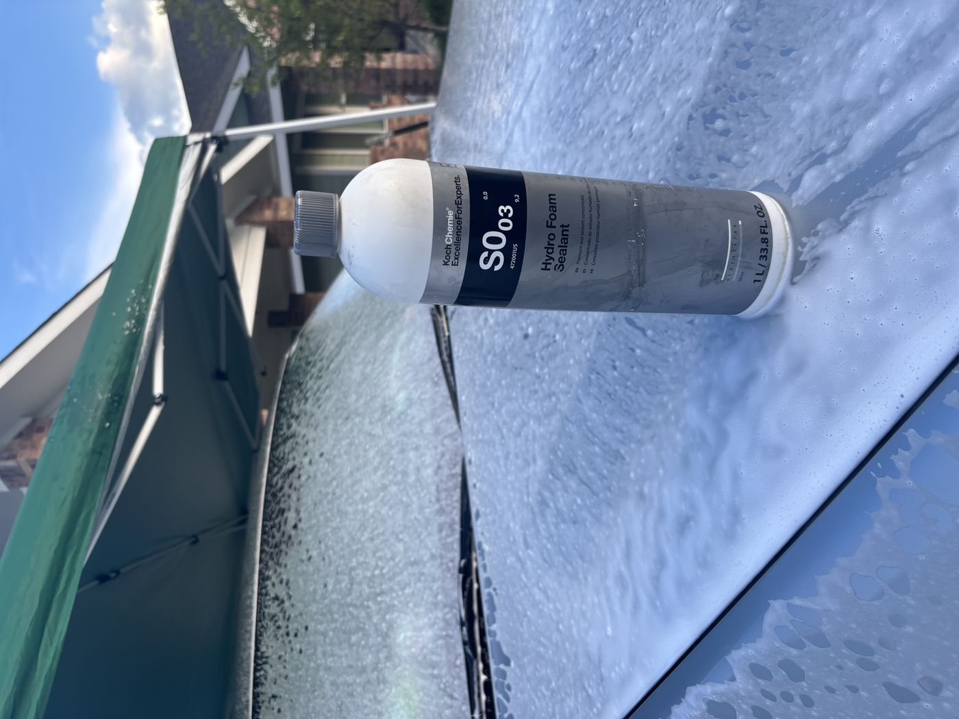 Hydro foam sealant being applied during a maintenance wash on a foam-covered hood