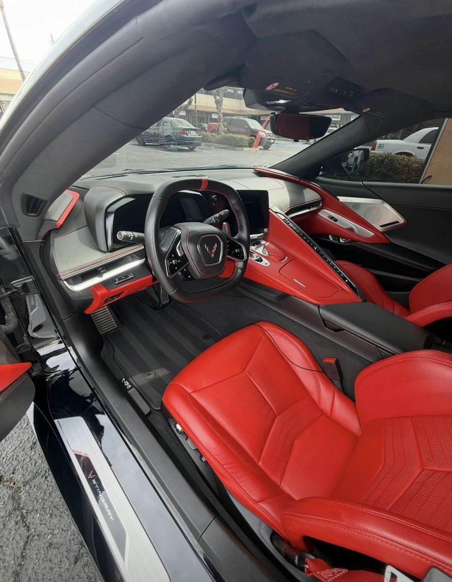 Red leather and carbon fibre car interior after a full mobile interior detail in Austin