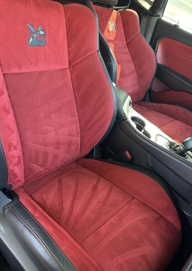Red Alcantara and perforated leather sport seats with embroidered headrests, re-napped and cleaned during an interior detail
