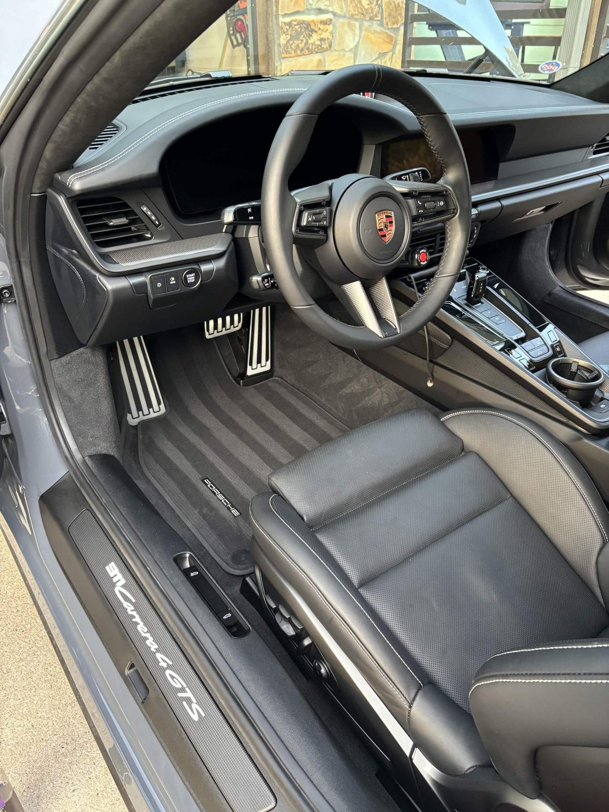 Porsche 911 Carrera 4 GTS black leather interior with contrast stitching and illuminated sill after an interior detail