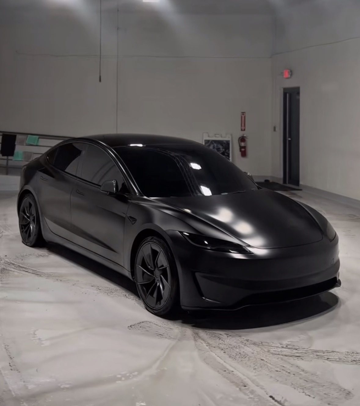 Satin black Tesla Model 3 Performance reflecting overhead lights after a ceramic coating install by Morello's in Austin