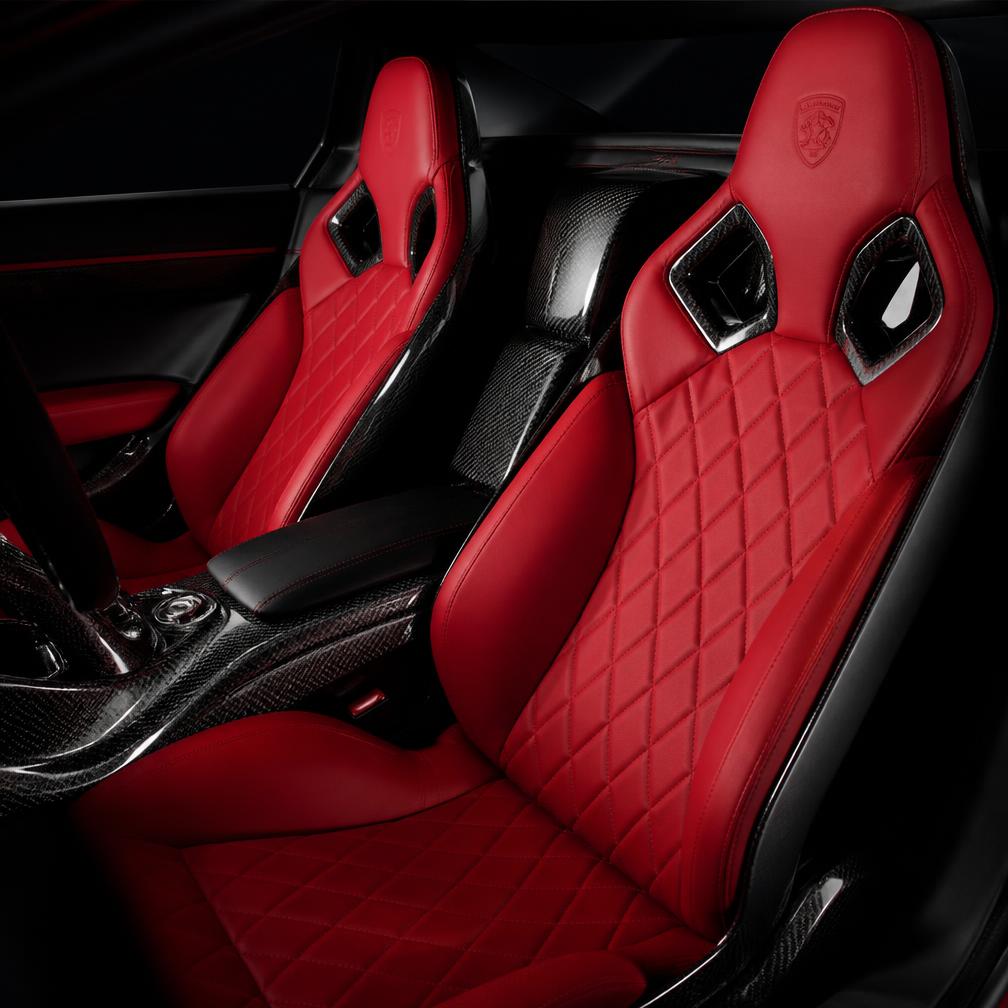 Immaculate red quilted leather and carbon fibre interior of an exotic car detailed by Morello's